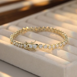 Macro shot of gold S925 sterling silver tennis bracelet with round cubic zirconia in box