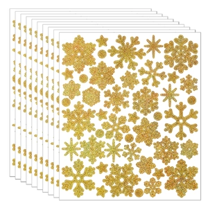 Detailed view of ten sheets of golden glitter snowflake and star stickers for Christmas DIY