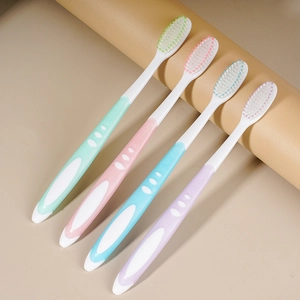 Four high-quality soft bristle toothbrushes for adults in green, pink, blue, and purple colors