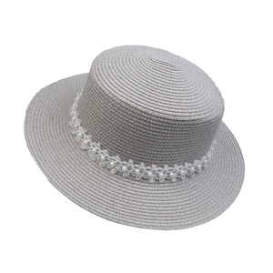 Detail showing grey flat top straw hat with white lace flowers and pearl beads decoration
