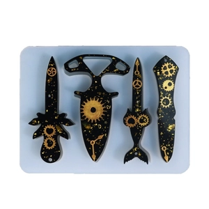 Steampunk silicone resin mold set featuring black and gold gear knife pendants