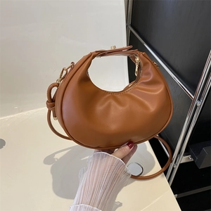 Caramel brown crescent moon leather handbag with gold zipper and detachable strap