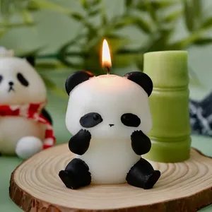 Handcrafted panda scented candle on a wooden base with a cozy glowing flame and soft lighting