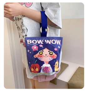 Detail of purple canvas bucket bag with cartoon print and stylish wooden ring handle