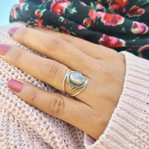 Bohemian silver ring with oval moonstone gemstone shown on a person's finger