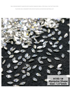 Macro detail of 1.5x3mm marquise-shaped zircons with sparkling facets on black background