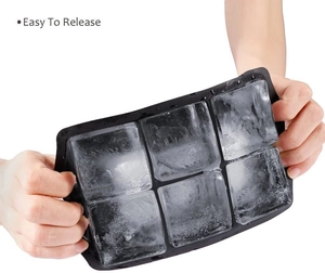 Flexible black silicone ice cube tray with 6 large squares showing easy release feature