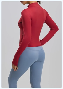 Detail of red slim fit sports jacket with reflective side lines and blue yoga leggings
