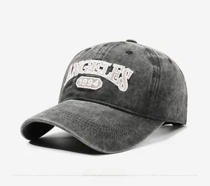 Macro detail of the vintage washed grey cotton fabric and 1994 embroidery on the baseball cap