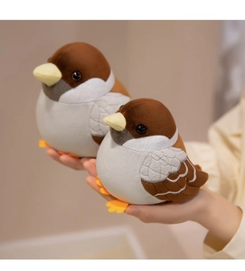 Close-up of small and large plush sparrow toys held in hand showing soft texture