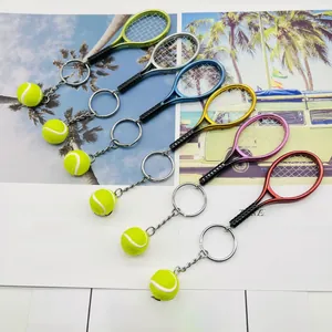 Detailed view of six colorful mini tennis racket keychains with yellow tennis ball charms