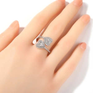Hip hop fashion silver ring with double heart-shaped diamonds on a model's hand