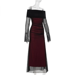 Detailed close-up of the burgundy lining and black mesh ruched fabric on the dress