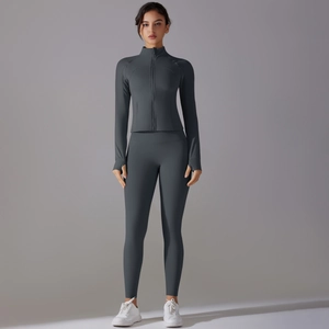 Detail of grey slim-fit yoga set showing thumb holes on sleeves and high-waist pants