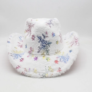 Detail of white plush cowboy hat featuring shiny colorful snowflake patterns for Christmas
