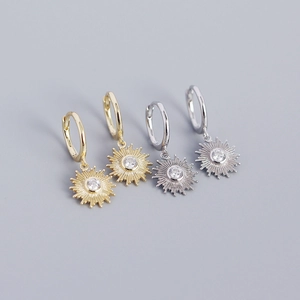 Detailed view of sunburst earrings with clear zircon in gold and silver finishes