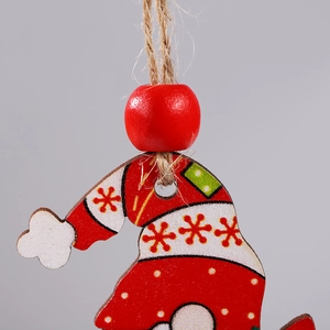 Close-up of painted wooden Christmas hat ornament with red beads and natural hemp rope loop