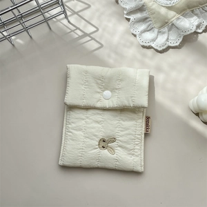 Detailed view of quilted cotton fabric with cute bunny embroidery and button closure
