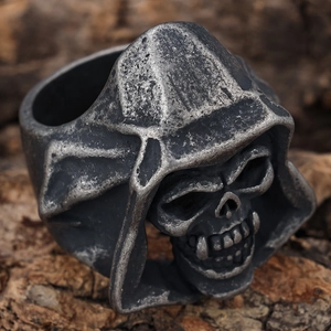 Retro hooded skull ring in dark silver stainless steel on natural wood background