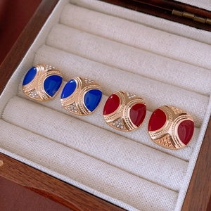 Detail view of vintage square enamel earrings with gold plating and sparkling rhinestones