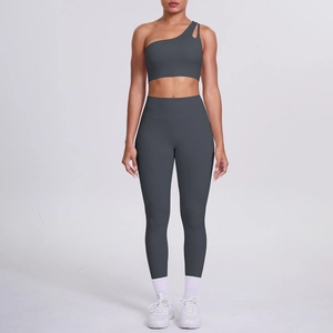 Detail of dark grey one-shoulder sports bra and high-waist yoga leggings set