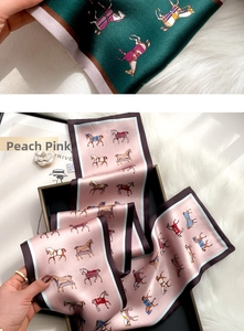 Detailed close-up of equestrian silk twilly scarf showing fine texture and horse patterns