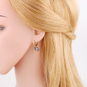 Detailed view of purple zircon-set bear earrings on a white model head display