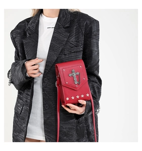 Red cross shoulder bag with metal star studs, trendy mini crossbody bag for women.