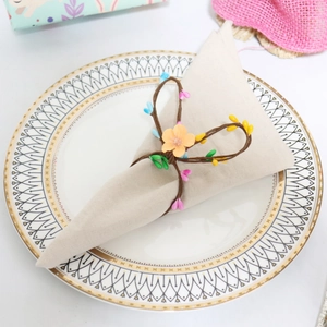 Detailed view of a handmade floral napkin ring with colorful berries and woven texture