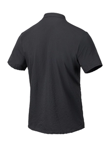 Close-up of black polo shirt featuring unique seersucker texture and pleated fabric detail
