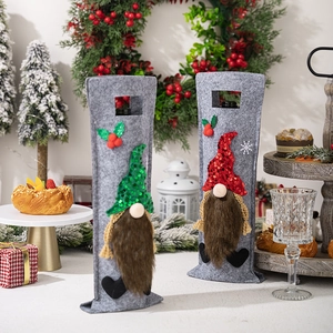 Close-up of gnome wine bottle covers with sequin hats and faux fur beards for holiday decor