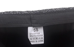 Detail view of winter cap lining with 58 size label and cotton polyester fabric blend