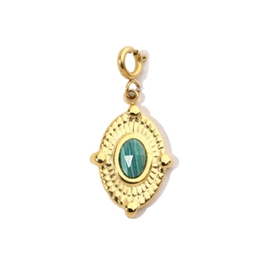Detail of vintage teardrop pendant with green stone and golden sunburst pattern