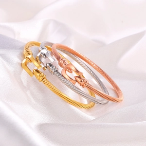 Three-color twisted cable bracelets with horseshoe buckles in gold, silver, and rose gold