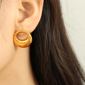 Minimalist 18K gold plated titanium steel oval hollow earring worn by a model