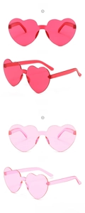 Detail of rimless heart sunglasses in vibrant rose red and soft pink jelly colors