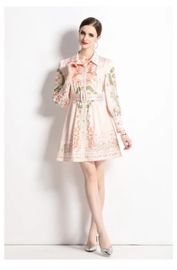 Close-up of the vintage coral print and smooth silk texture on a V-neck long sleeve dress