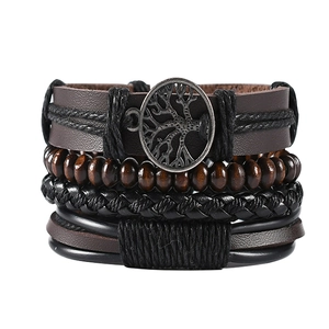 Detailed view of multilayer leather bracelet with tree of life charm and wooden beads