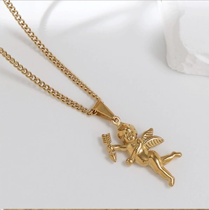 Macro shot of gold plated cupid angel pendant on vintage stainless steel curb chain
