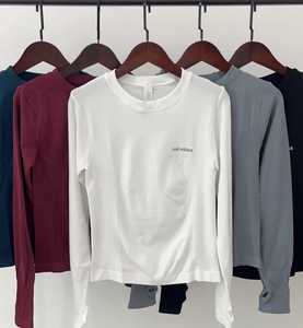 Detail of slim-fit yoga tops featuring long sleeves with thumbholes in multiple colors