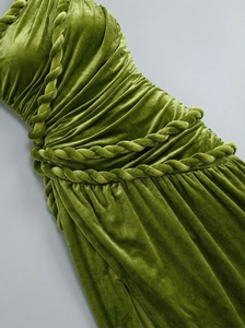 Detail of olive green velvet dress featuring an intricate hand-woven rope decoration