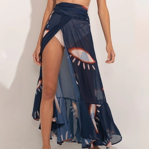 Detail of sheer navy blue sarong featuring abstract eye print and ruffle hem trim