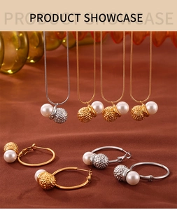 Peanut-shaped shell pearl pendants on snake chains and matching hoop earrings set