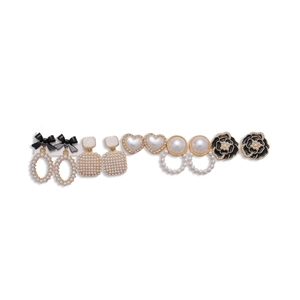 Elegant 6-pair gold earrings set with pearls, black bows, hearts, and flower designs