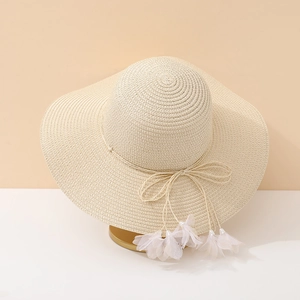 Elegant wide brim straw hat with bow and white tulle petals for summer beach vacation