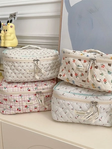 Quilted cotton cosmetic bag with floral and cherry patterns for travel storage