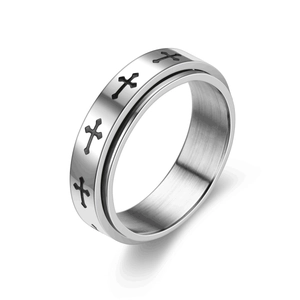 Détail d'une bague rotative en acier titane avec motif de croix noires gravé dessus