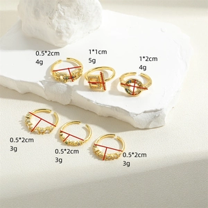 Set of 6 gold adjustable open rings with colorful zircons and Saturn charm on stone