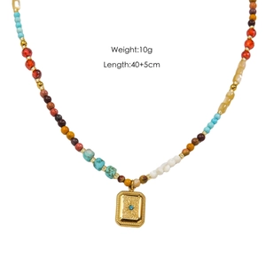 Ethnic natural stone beaded necklace with a golden tiger eye pendant on a white background