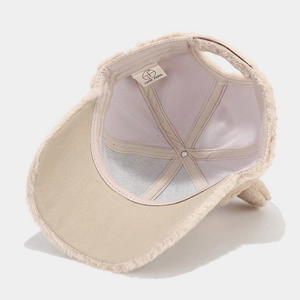 Detail of plush cat ear baseball cap showing inner mesh lining and high-quality stitching